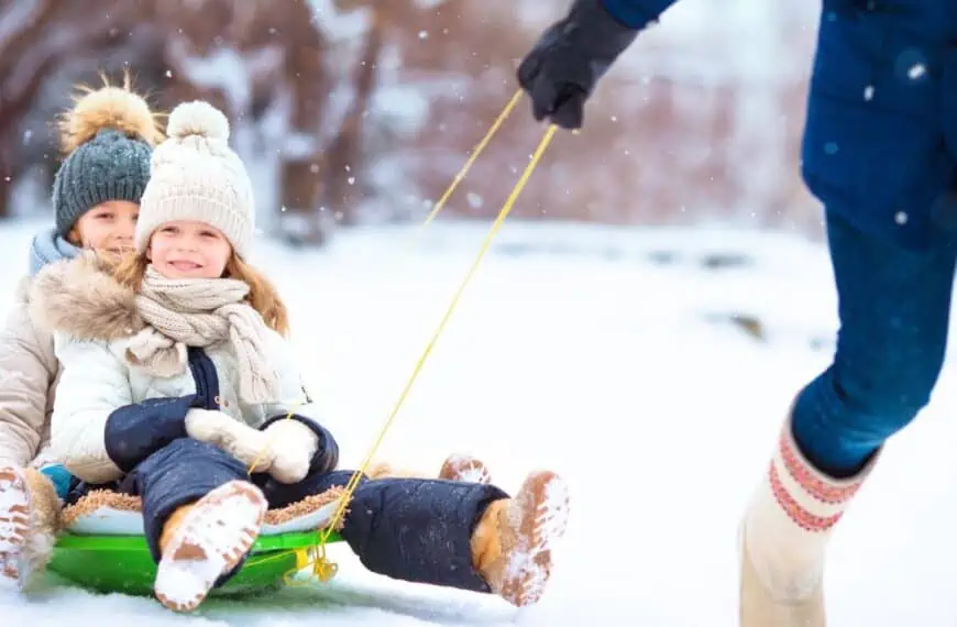 family winter vacation sledding