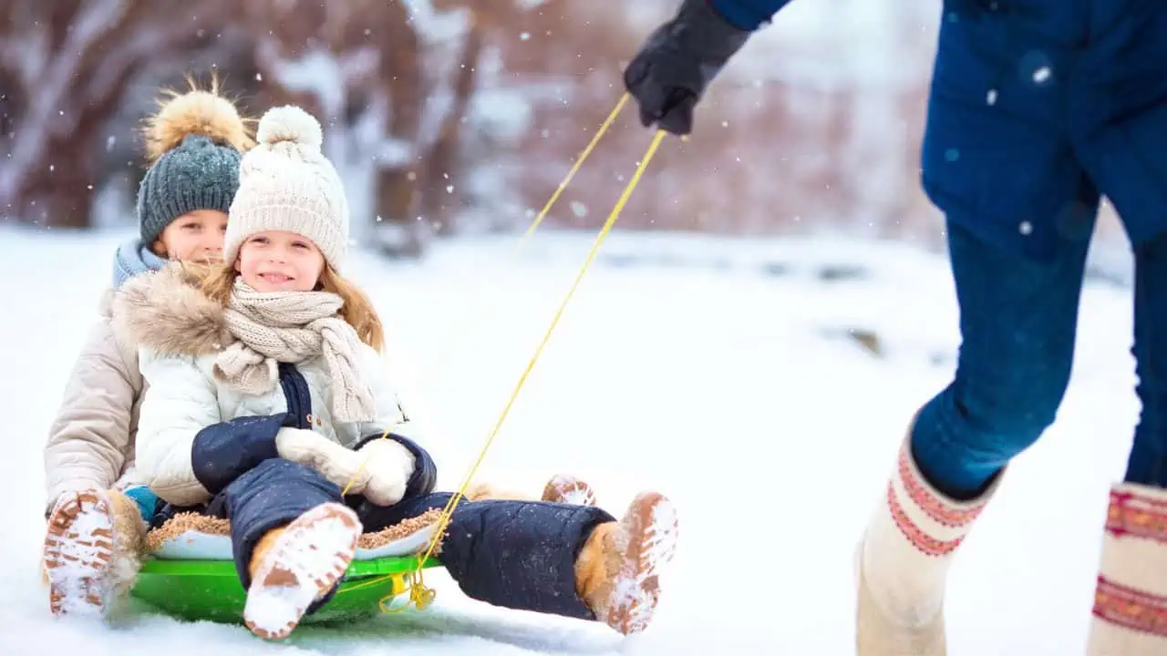 family winter vacation sledding