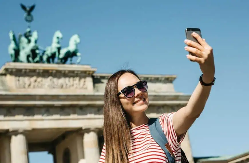 Woman making selfie in front of Branderburger Tor, Berlin, Germany