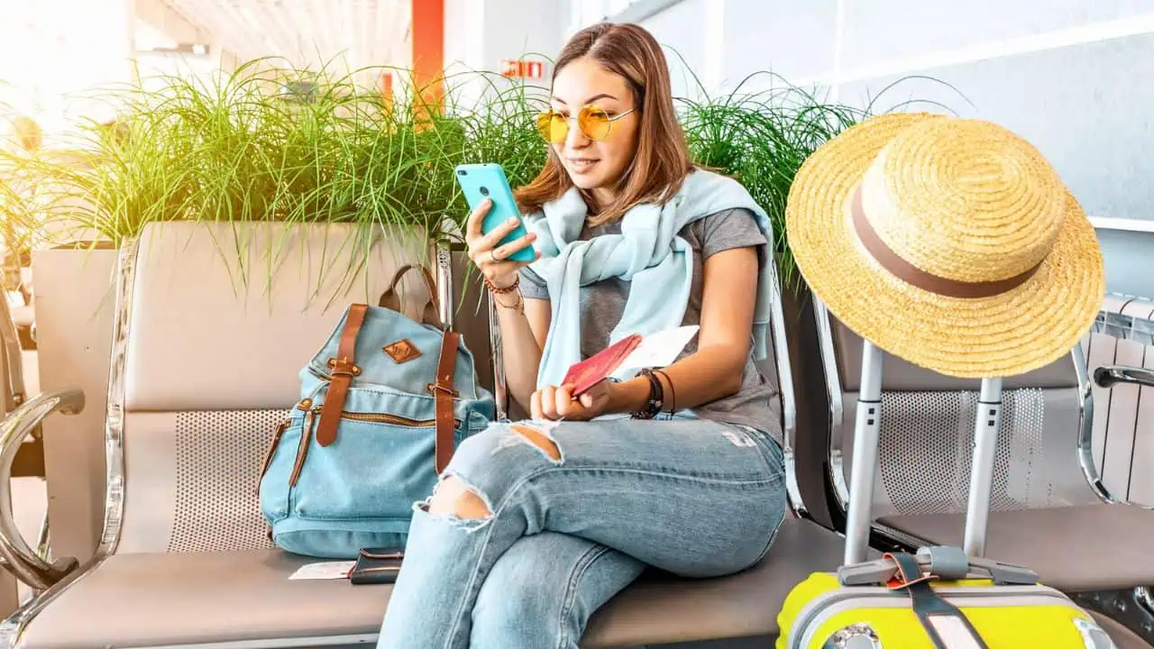 Woman waiting in airport on phone