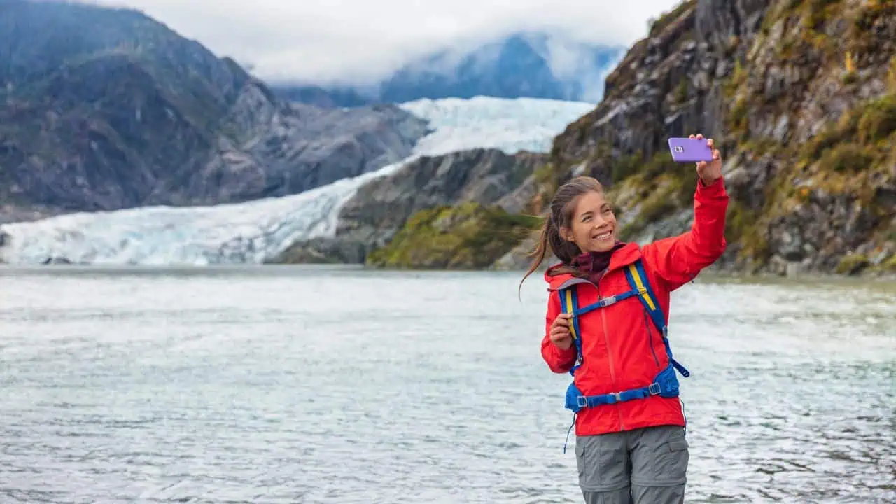 Tourist woman at Juneau glacier Alaska USA