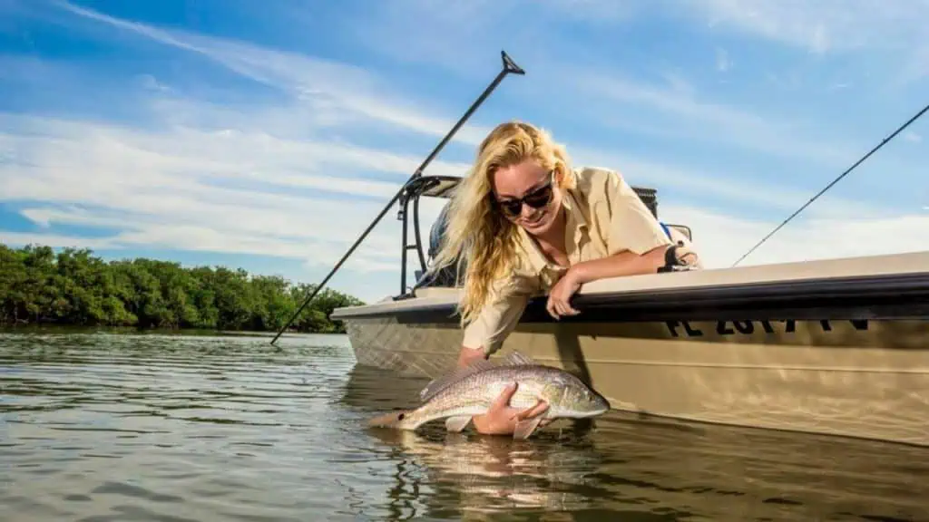 Woman catching Redfish in Space Coast Florida