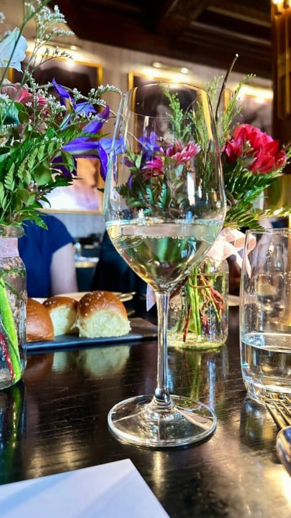 Wine glass and flowers at Q at the Empress